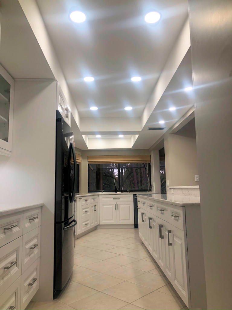 Classic White Kitchen Remodel in Carrollwood Village with custom lighting